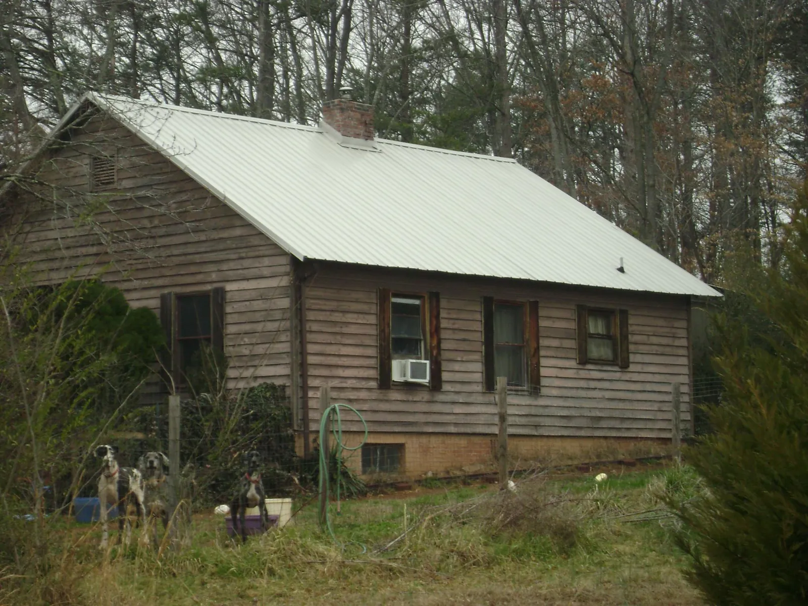 White metal roof on an old wood sided farmhouse, from a Metal Roof Installation job in Galva